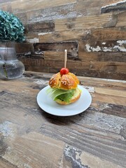 homemade hamburgers with tomato on a white plate