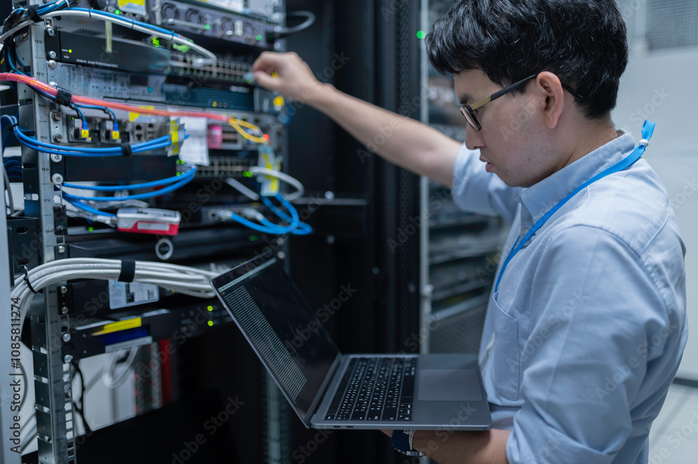 Wall mural computer engineer is setting up network in server room,systems maintenance technician,male engineer 