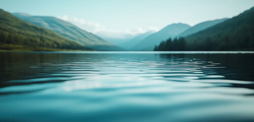 Lake water surface in the background blurred mountain landscape. 
