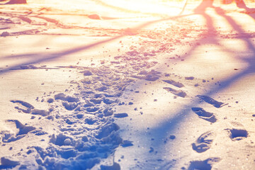 View of footprints in the snow during sunset - Powered by Adobe