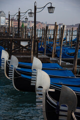 Gondolas bobbing on the water, moored on the jetty near the Piazzetta San Marco