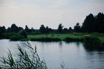 View of golfers walking  in golf course