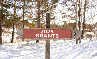 Planning 2025 grants new year symbol. Concept words 2025 Grants on beautiful wooden old retro vintage road sign. Beautiful winter forest background. Business 2025 grants new year concept. Copy space.