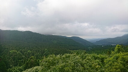 Fototapeta premium Nantou, Taiwan - 8.10.2018: A breathtaking view of rolling forested hills blanketed by an overcast sky, evoking serenity and natural beauty in the Xitou Nature Education Area