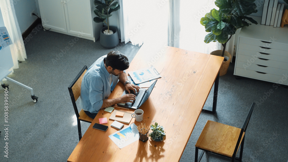 Poster skilled project manager walking at table while working on laptop. skilled business team working toge