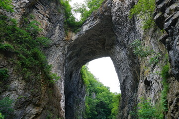 View from below on the landmark rock formation and stone arch of Natural Bridge State Park in the mountains of Virginia, United States of America