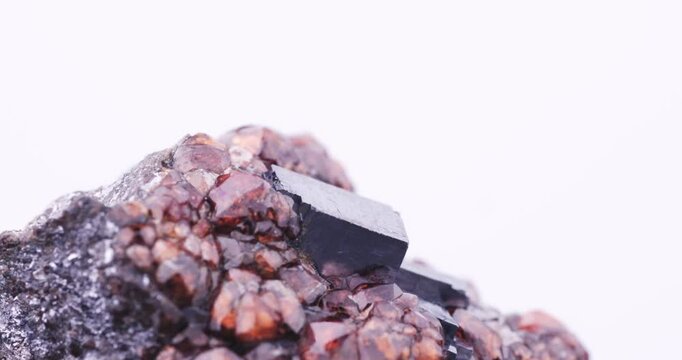 Orange Spessartine with Galena. rotating footage. Specimen from Potos&iacute; Mine, Francisco Portillo, Mexico. macro detail close-up mineral crystal unpolished semi-precious gemstone.