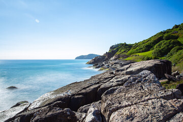 Fierce waves splashing at surf beach in Brasil.
Amazing Florianópolis smooth view of waves moving in a paradise sea with emerald water and abundant vegetation. Emerald green colors.