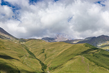 Caucasian mountains near Gergeti village, Stepansminda. Kazbegi mountain behind the clouds. Georgia