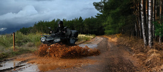 Offroad with an ATV in the forest, mud and puddles after the rain © cn.ycl