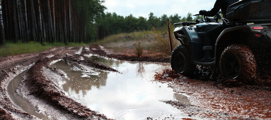 Offroad with an ATV in the forest, mud and puddles after the rain © cn.ycl
