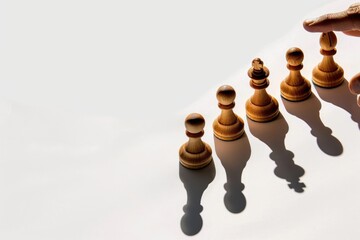 Chess Pieces in a Row with a Hand Reaching Towards the Front