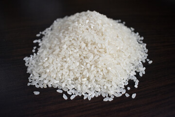 Rice pile side view. Uncooked rice isolated on black background with clipping path, side view