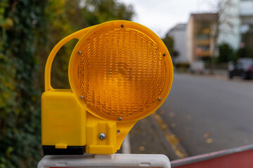 A close-up view of a portable, yellow safety light