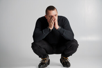 Contemplative Man in Athletic Wear Expressing Deep Thought
