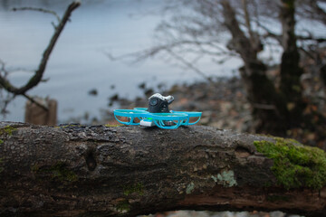 A series of photos showcasing the process of preparing and operating a small FPV drone outdoor. The...