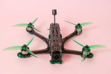 Close up view on modern drone with camera isolated on pink background