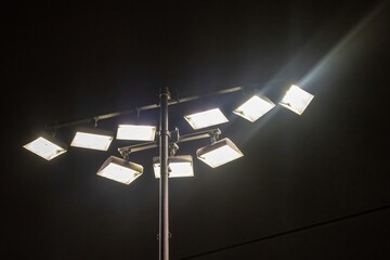 Bright stadium lights illuminating the night sky