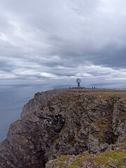 The view of a cliff with a globe at Nordkapp (North Cape), the second northernmost point of Europe, on Mageroya Island, Norway