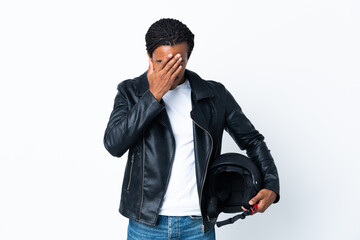 African American man with braids holding a motorcycle helmet isolated on white background with tired and sick expression