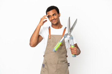 African American gardener man holding pruning shears over isolated white background laughing
