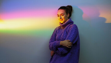 Rainbow mood. Art portrait. Dreamlike girl. Peaceful relaxed smiling model posing on glowing blur gradient color reflection copy space background.