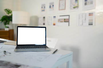Fototapeta premium Empty white screen laptop. blank white screen. Mockup image in office