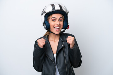 Young caucasian woman with a motorcycle helmet isolated on white background celebrating a victory in winner position