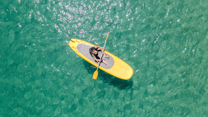 Aerial top view of a kayak in the emerald water in the Caribbean. Calm waters in a pristine and transparent sea.

Aerial top view of a kayak and emerald water in the Caribbean.