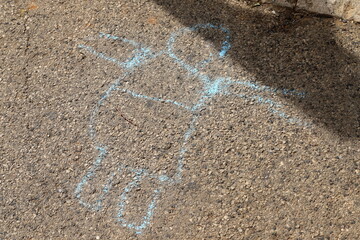Children's chalk drawings on the sidewalk in the city.