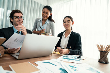 Fototapeta premium Diverse group of business analyst team analyzing financial data report paper on office table. Chart and graph dashboard by business intelligence analysis for strategic marketing planning Habiliment