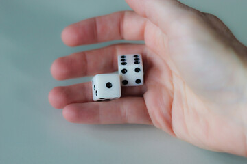 Hand throwing pair of dice game metaphor life unpredictability chance entertainment isolated on...