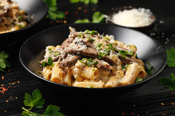 Philly cheese steak pasta in black bowl