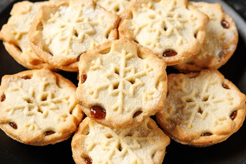 British Christmas mince pies or fruit pie with decoration, gifts, green tree branch