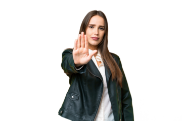 Young beautiful woman over isolated chroma key background making stop gesture