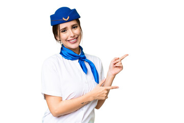 Airplane stewardess over isolated chroma key background pointing finger to the side and presenting a product