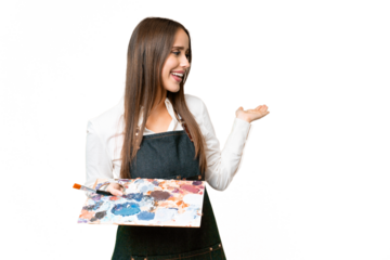 Young artist woman holding a palette over isolated chroma key background with surprise expression while looking side