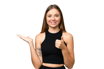 Young blonde woman over isolated chroma key background holding copyspace imaginary on the palm to insert an ad and with thumbs up