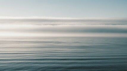 Fototapeta premium Atmospheric Horizon: An ethereal scene unfolds, the sky and sea merge in soft, blurred strokes of color, evoking a sense of tranquility and boundless space.