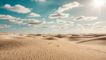 Naklejka premium Desert Vista: A vast, undulating expanse of sand dunes stretches towards the horizon under a bright, sunny sky adorned with fluffy clouds. This evokes a sense of both desolation and beauty.
