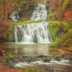 view to central part of double cascades waterfall in autumn canyon