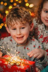 A young boy and girl holding a wrapped Christmas gift together