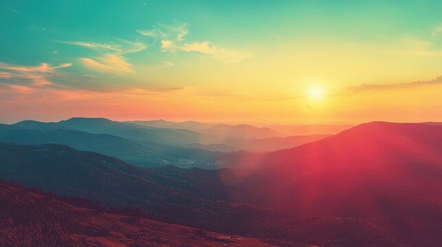 Panoramic view of a colorful sunrise in the mountains with a cross-processed vintage effect.