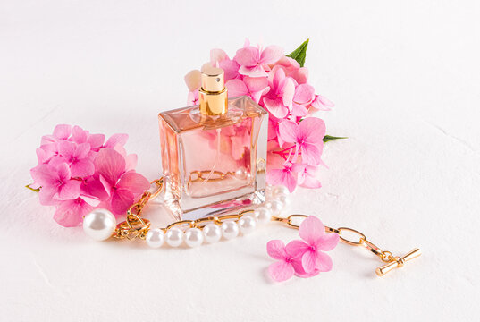 Elegant perfume bottle with pink flowers and pearls