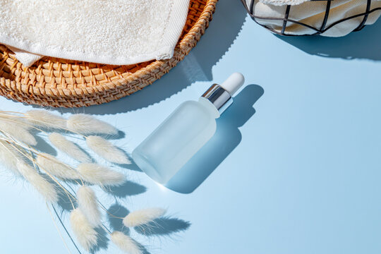 Minimalist beauty scene with cosmetic bottle and natural elements