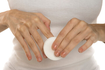 Woman removing polish from nails with cotton, closeup.
