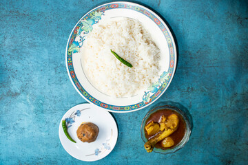 Plain Rice with Chicken curry korma and alu bhorta served in plate isolated on grey background top view of bangladeshi food