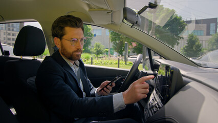 Business man inside modern electric car travel driving automobile in city displeased confused...