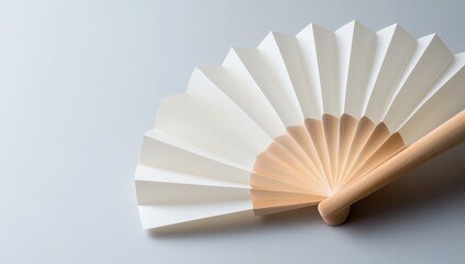 Delicate White Paper Folding Fan Standing Upright on Gray Background