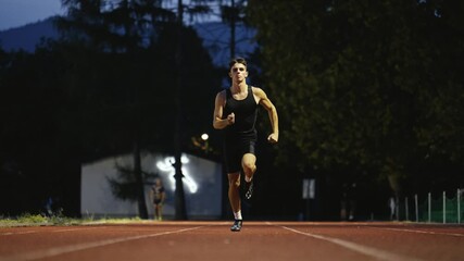 Male Athlete is Running Towards an Obstacle, Hurdling, Jumping Over the Barrier at High Speed while Sprinting in a Race. Cinematic Super Slow Motion